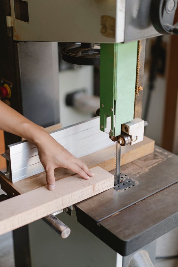 Mastering the First Impression: Your intriguing post title goes here Crop unrecognizable woodworker sawing wooden plank with band saw with sharp blade in daytime