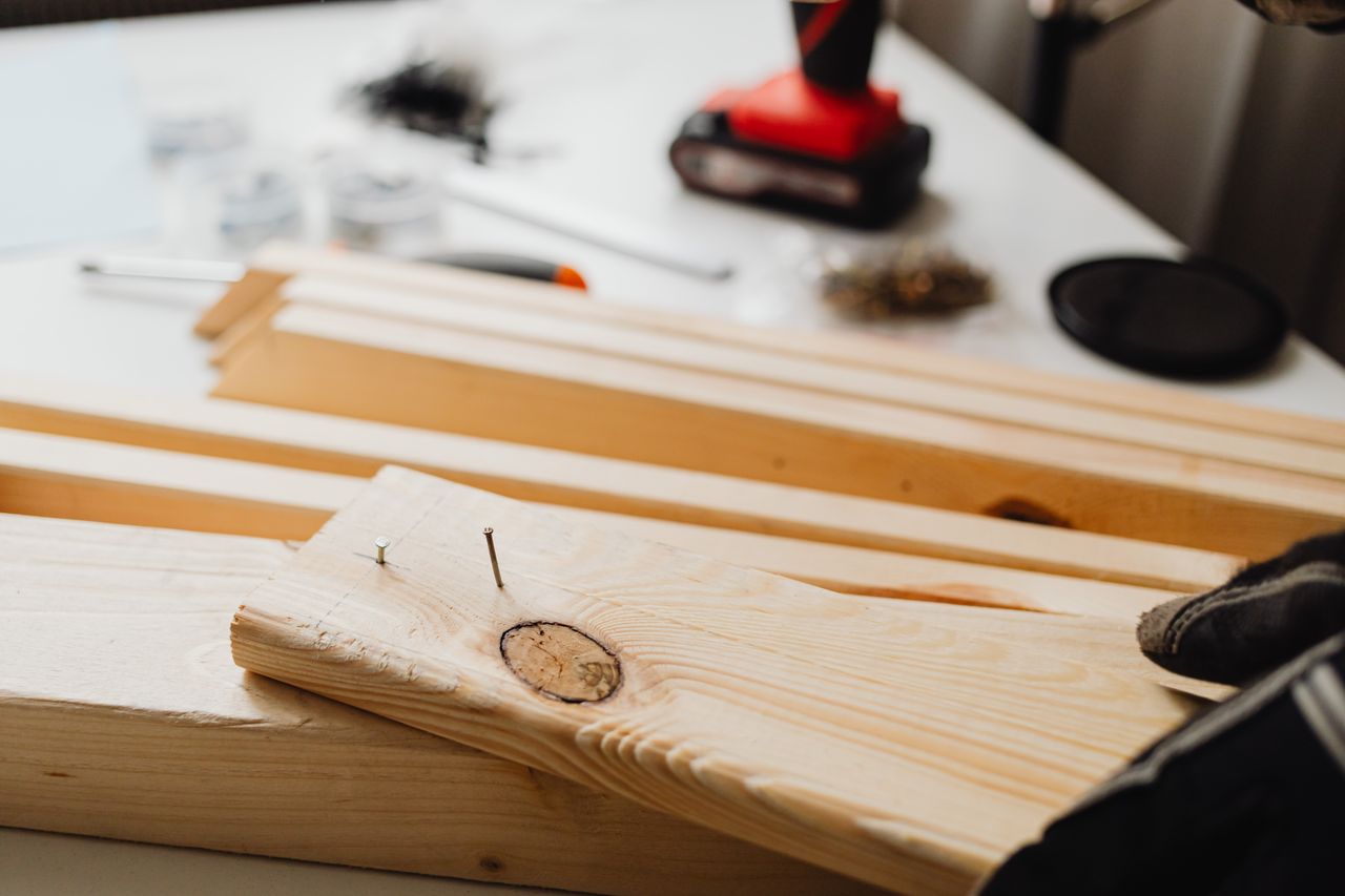 Crafting Captivating Headlines: Your awesome post title goes here Close-up of woodworking, showing a power drill and wooden planks for DIY projects.